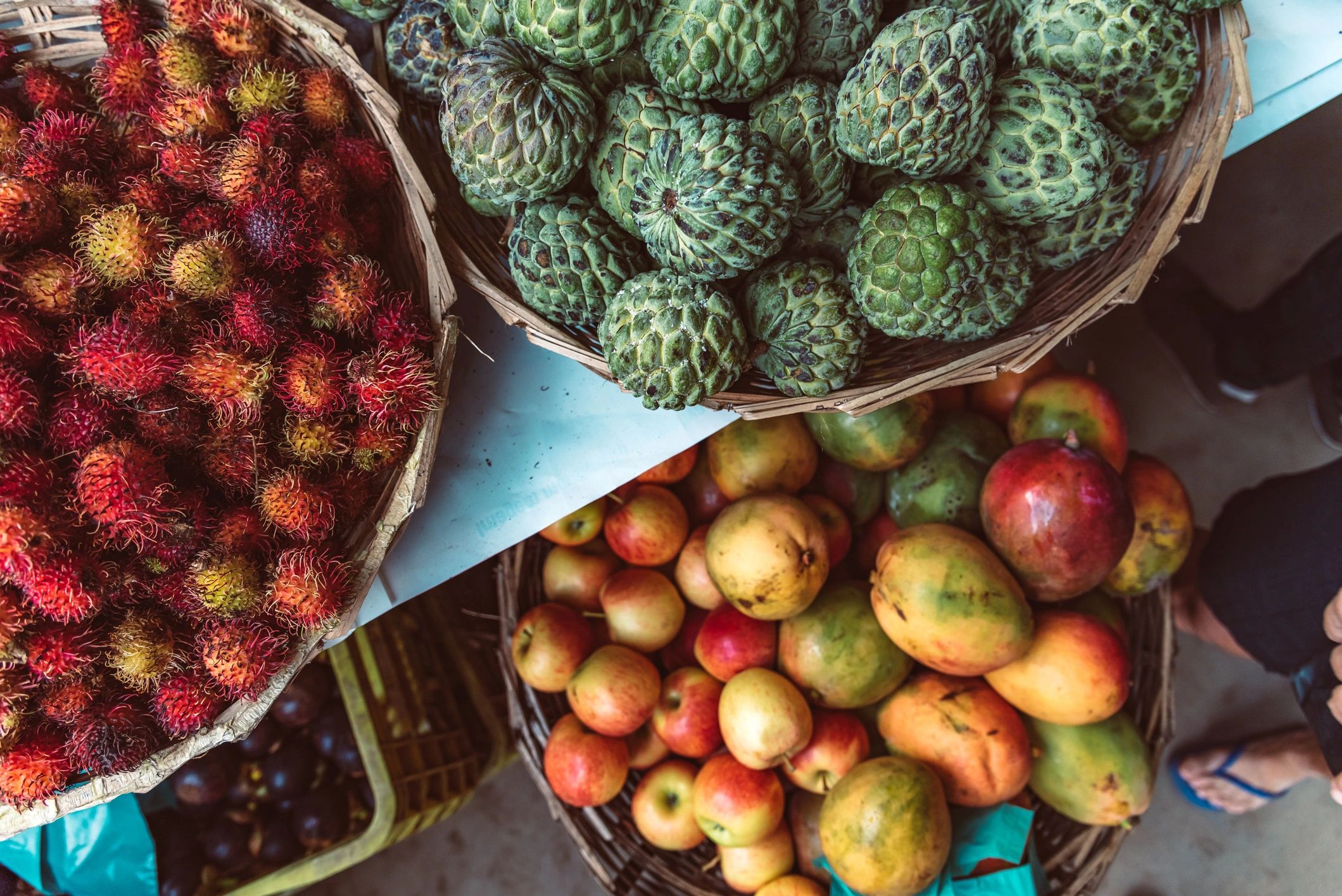 Assorted tropical fruits in baskets at a market