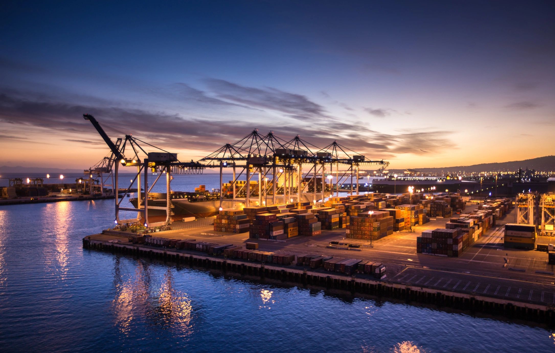 Container port at sunset representing global export logistics
